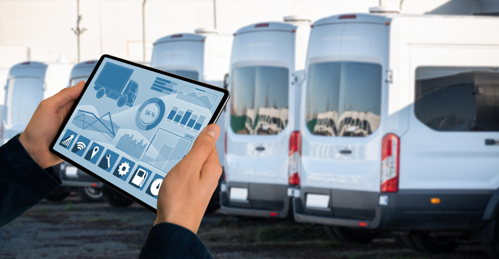 Manager with a digital tablet on the background of trucks. Fleet